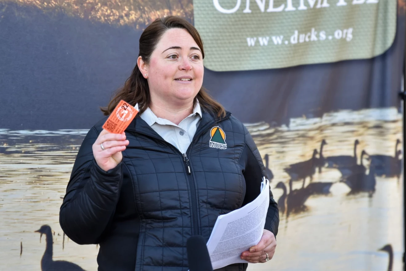 Executive Director of Michigan United Conservation Clubs Amy Trotter holds up a hunting permit to illustrate that hunters are willing to pay for habitat improvements. Now MUCC wants the state to pitch in additional money.